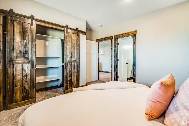 2869 S Chukar Dr Unit 63, Garden City, UT 84028 - carpeted bedroom with a barn door