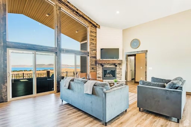 2869 S Chukar Dr Unit 63, Garden City, UT 84028 - living room with a stone fireplace, beam ceiling, high vaulted ceiling, and wood finished floors
