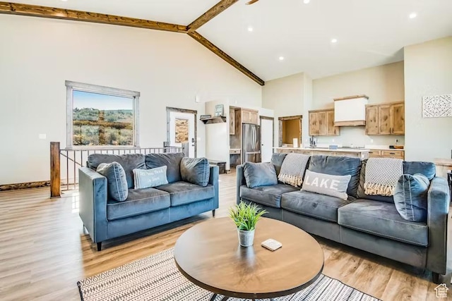 2869 S Chukar Dr Unit 63, Garden City, UT 84028 - living area featuring light wood-type flooring, baseboards, and high vaulted ceiling