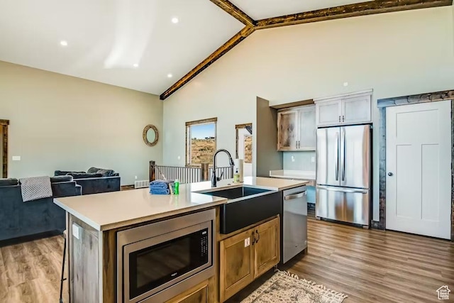 2869 S Chukar Dr Unit 63, Garden City, UT 84028 - kitchen with light countertops, stainless steel appliances, a kitchen island with sink, and a sink