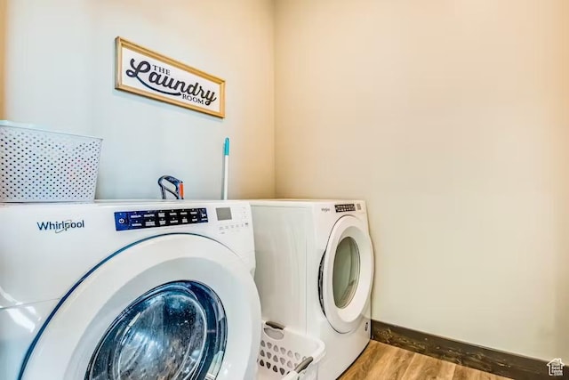 2869 S Chukar Dr Unit 63, Garden City, UT 84028 - washroom with washer and dryer, laundry area, wood finished floors, and baseboards