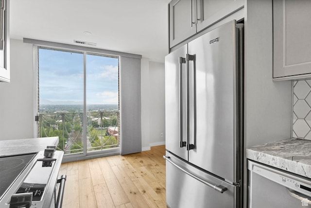 777 E S Temple S Unit 11B, Salt Lake City, UT 84102 - kitchen featuring light wood-style flooring, stainless steel appliances, gray cabinetry, visible vents, and light countertops