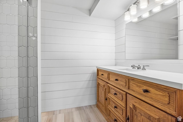 777 E S Temple S Unit 11B, Salt Lake City, UT 84102 - bathroom featuring vanity, wood finished floors, and a tile shower