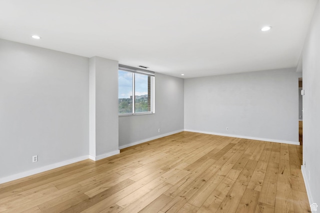 777 E S Temple S Unit 11B, Salt Lake City, UT 84102 - unfurnished room with baseboards, light wood finished floors, and recessed lighting