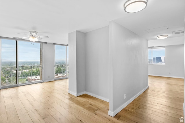 777 E S Temple S Unit 11B, Salt Lake City, UT 84102 - spare room with baseboards, a wealth of natural light, and wood-type flooring