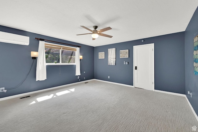 unfurnished room featuring an AC wall unit, ceiling fan, carpet, and baseboards