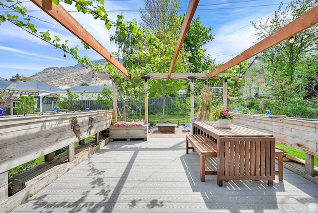 view of patio with a deck with mountain view, a fenced backyard, and outdoor dining space