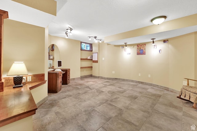 finished basement with rail lighting
