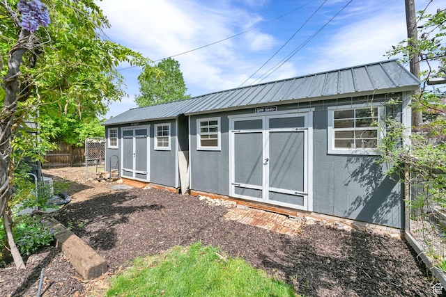 view of shed featuring fence