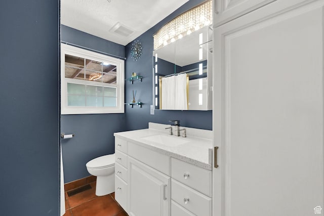 full bathroom featuring toilet, vanity, tile patterned floors, and curtained shower
