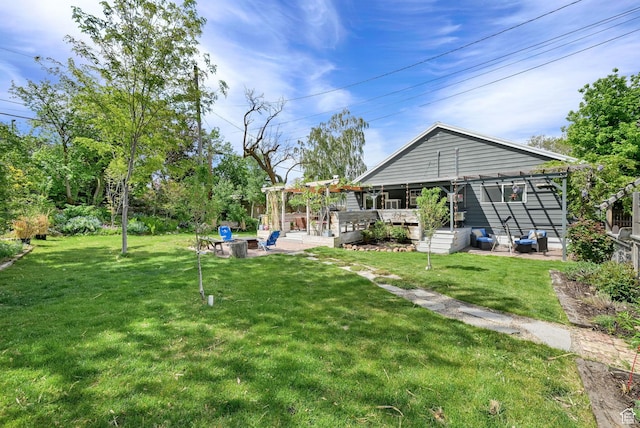 view of yard featuring a pergola, a patio area, and a deck