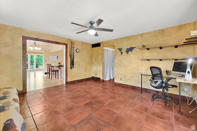 office space featuring tile patterned flooring, ceiling fan with notable chandelier, baseboards, and visible vents