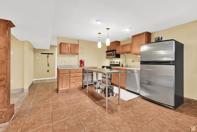 kitchen with appliances with stainless steel finishes, light countertops, decorative light fixtures, baseboards, and light tile patterned flooring