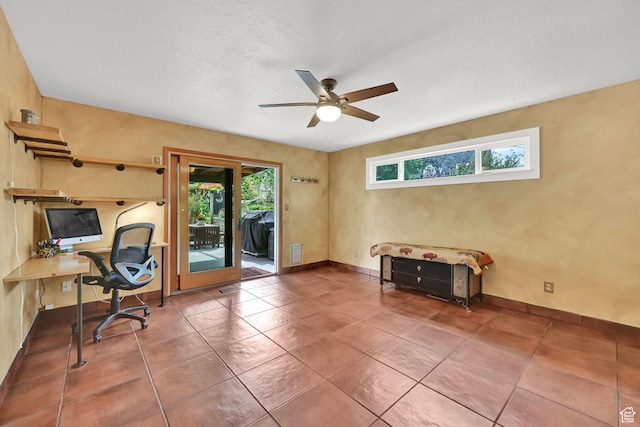 office area featuring ceiling fan, tile patterned flooring, and baseboards