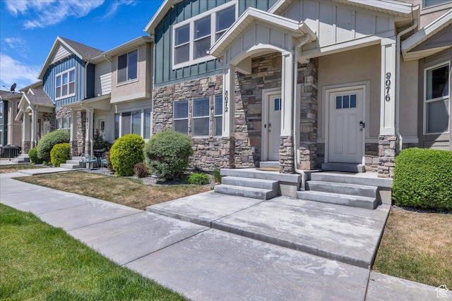 8072 N Rock Creek Cove Ln, Eagle Mountain, UT 84005 - doorway to property featuring board and batten siding and stone siding