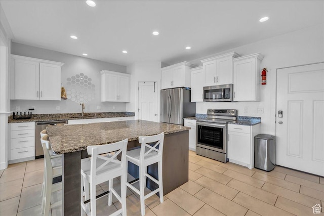 8072 N Rock Creek Cove Ln, Eagle Mountain, UT 84005 - kitchen with a sink, recessed lighting, white cabinets, and appliances with stainless steel finishes