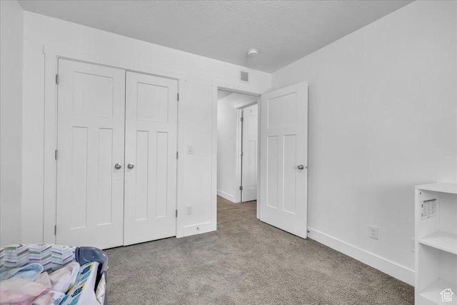 8072 N Rock Creek Cove Ln, Eagle Mountain, UT 84005 - unfurnished bedroom featuring a closet, carpet floors, a textured ceiling, visible vents, and baseboards