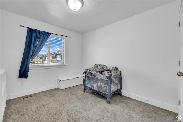 8072 N Rock Creek Cove Ln, Eagle Mountain, UT 84005 - bedroom with a textured ceiling, visible vents, baseboards, and carpet floors