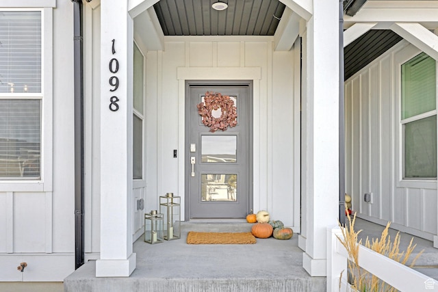 doorway to property featuring covered porch and board and batten siding