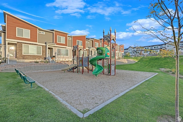 community playground featuring a lawn and a residential view
