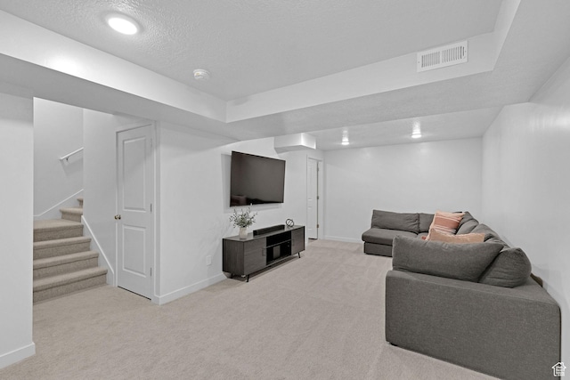 living room with baseboards, stairs, light carpet, and visible vents