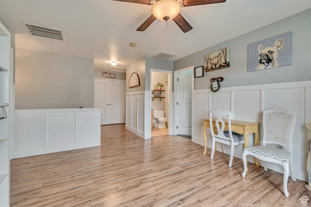 13623 S Blayde Dr W, Herriman, UT 84096 - sitting room with a decorative wall, a wainscoted wall, visible vents, ceiling fan, and light wood finished floors
