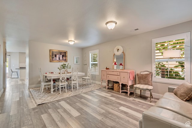 13623 S Blayde Dr W, Herriman, UT 84096 - living room with wood finished floors, visible vents, and baseboards