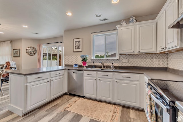 13623 S Blayde Dr W, Herriman, UT 84096 - kitchen with a peninsula, a sink, white cabinets, visible vents, and appliances with stainless steel finishes