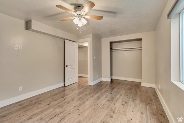 13623 S Blayde Dr W, Herriman, UT 84096 - unfurnished bedroom with light wood finished floors, a ceiling fan, a closet, a textured ceiling, and baseboards