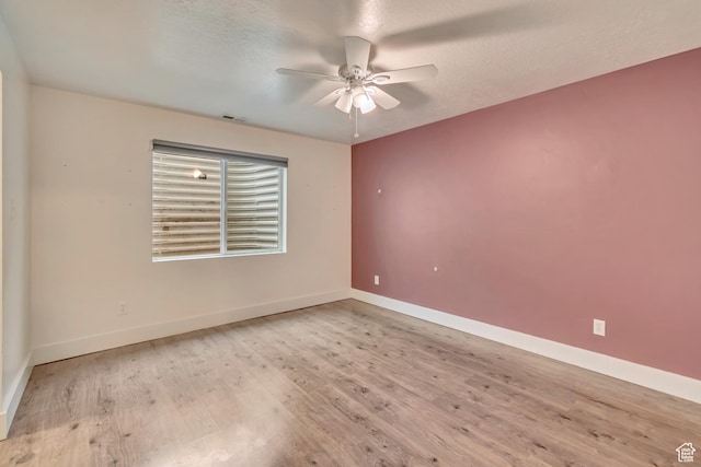 13623 S Blayde Dr W, Herriman, UT 84096 - spare room featuring visible vents, wood finished floors, baseboards, and ceiling fan