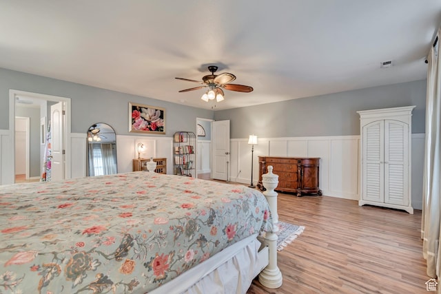13623 S Blayde Dr W, Herriman, UT 84096 - bedroom featuring a decorative wall, visible vents, light wood-style flooring, a ceiling fan, and wainscoting