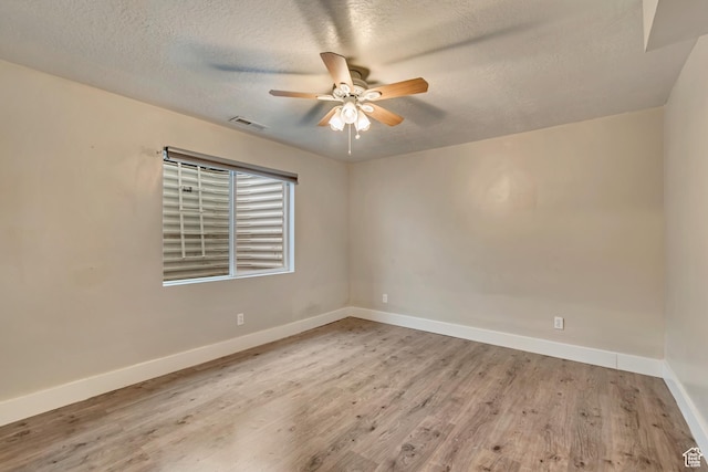 13623 S Blayde Dr W, Herriman, UT 84096 - spare room featuring a textured ceiling, baseboards, ceiling fan, visible vents, and wood finished floors