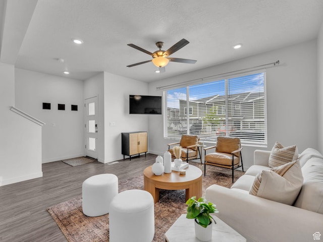 living area featuring baseboards, recessed lighting, ceiling fan, and wood finished floors