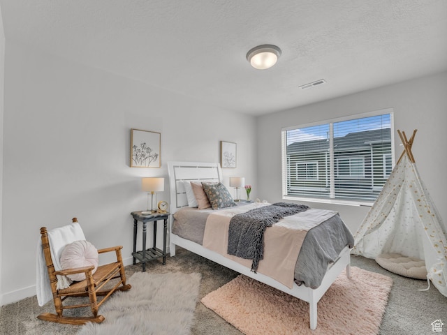 bedroom featuring a textured ceiling, visible vents, baseboards, and carpet floors