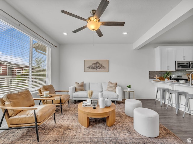 living area featuring baseboards, recessed lighting, ceiling fan, and wood finished floors