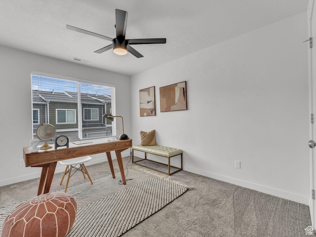 carpeted office with baseboards, a ceiling fan, and visible vents