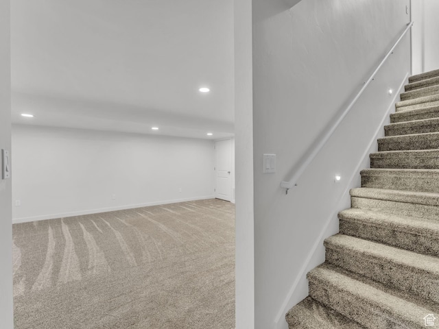 stairway featuring baseboards, carpet flooring, and recessed lighting