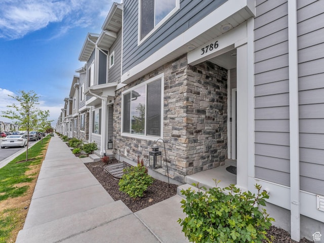 view of side of home featuring stone siding