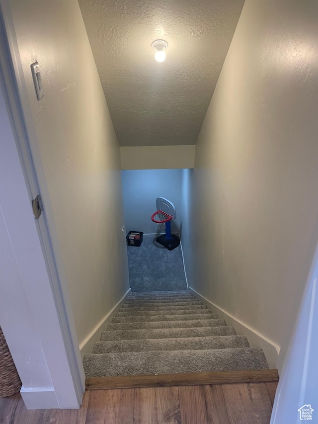 279 E Grace Ln, North Salt Lake, UT 84054 - staircase featuring a textured ceiling and baseboards