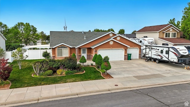 view of front of home featuring driveway, fence, an attached garage, stucco siding, and a front lawn