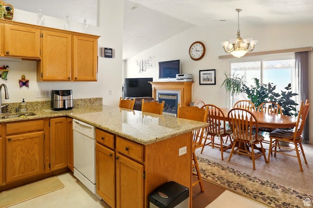 kitchen featuring a peninsula, a sink, a notable chandelier, vaulted ceiling, and white dishwasher