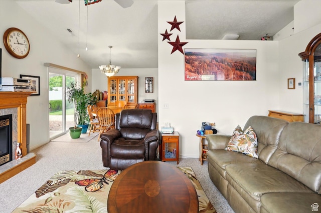 carpeted living area with ceiling fan with notable chandelier, visible vents, vaulted ceiling, a fireplace, and baseboards