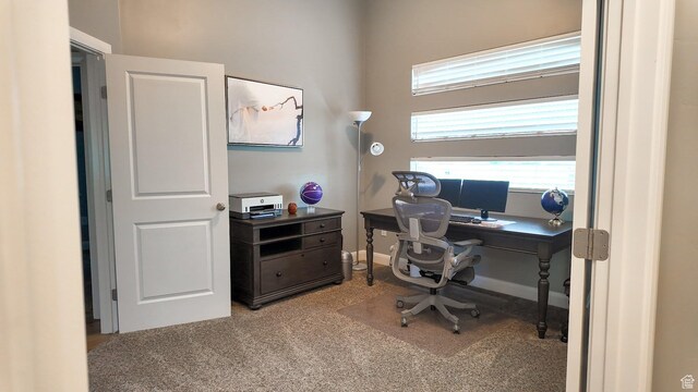 carpeted home office with baseboards