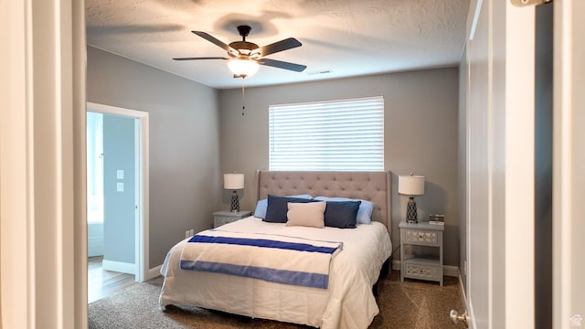 bedroom with carpet flooring, visible vents, baseboards, and a ceiling fan