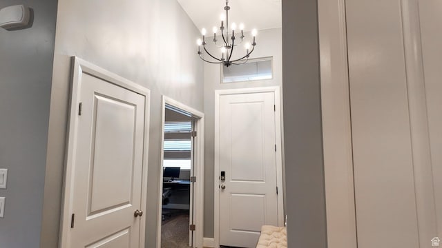 doorway featuring a notable chandelier