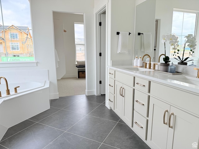 full bath featuring a garden tub, double vanity, and tile patterned floors