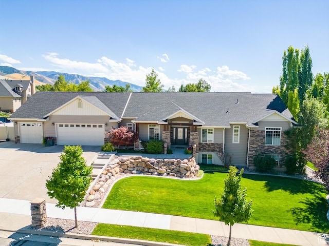 878 E 400 S, Smithfield, UT 84335 - craftsman inspired home with stone siding, concrete driveway, a garage, a front lawn, and a mountain view