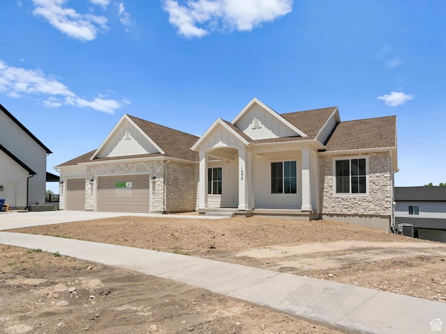 1336 W 800 S Unit 22, Spanish Fork, UT 84660 - view of front facade with board and batten siding, a porch, an attached garage, and stone siding