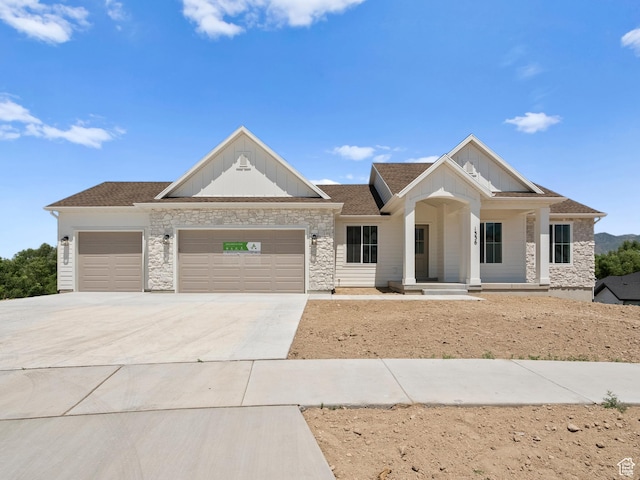 1336 W 800 S Unit 22, Spanish Fork, UT 84660 - view of front facade with board and batten siding, a garage, stone siding, and concrete driveway