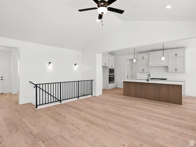 1336 W 800 S Unit 22, Spanish Fork, UT 84660 - kitchen with appliances with stainless steel finishes, high vaulted ceiling, light countertops, a ceiling fan, and an island with sink